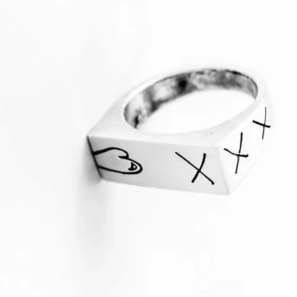 Matti sterling silver XXX signet ring photographed on white